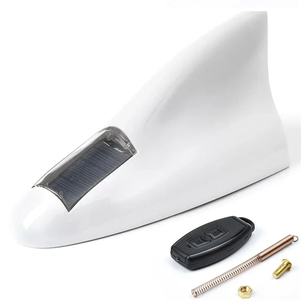 LED shark fin antenna mounted on black car white